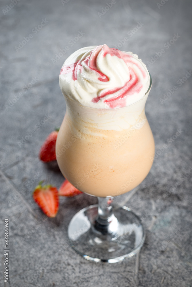 Strawberry milkshake in a glass on a leg Strawberry milkshake in a glass on a leg