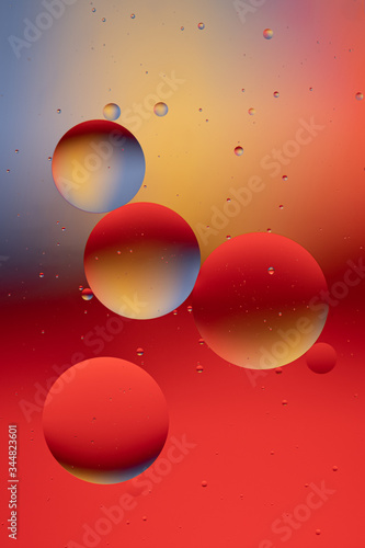 Abstract view of oil drops in water and coloured paper