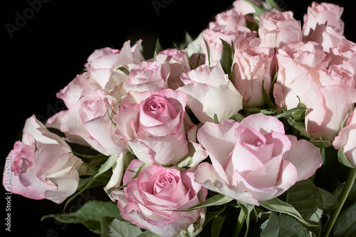 Close-up of a flower bouquet with pink roses isolated on a black background