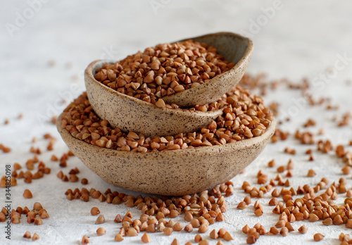 Raw dry buckwheat grain in bowls