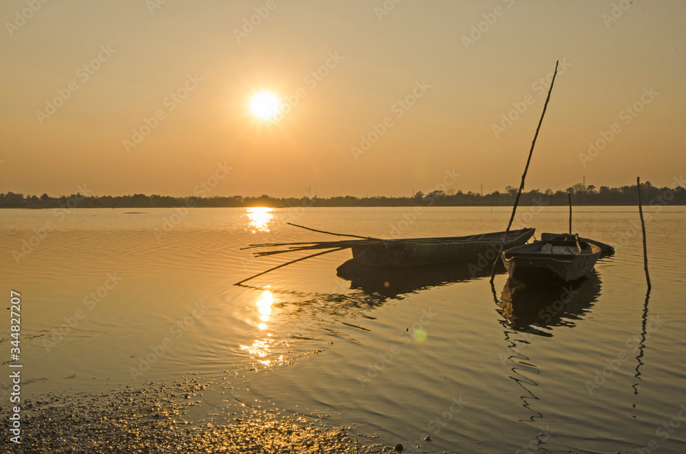 Floating two boats in the water under evening sunlight Floating two boats in the water under evening sunlight