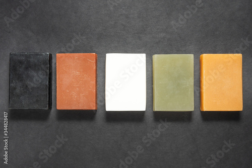 Set of different handmade soap on black background, mock up