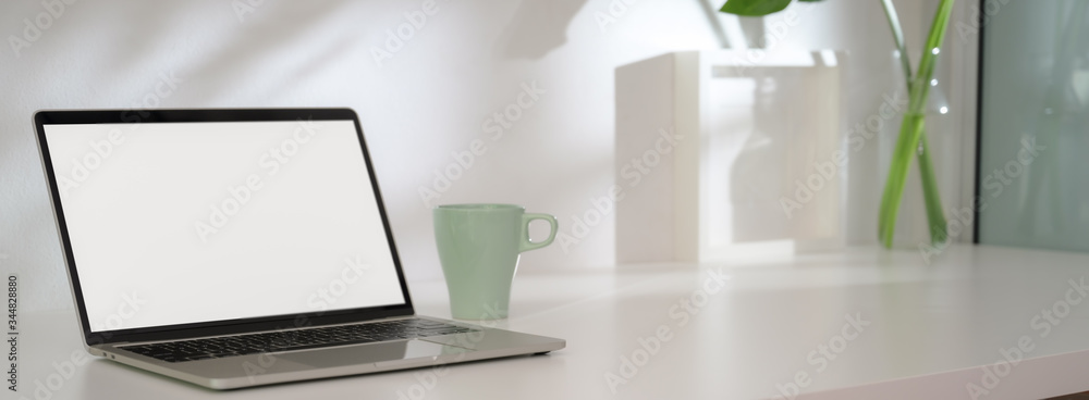 Cropped shot of modern home office with mock-up laptop, decorations and copy space Cropped shot of modern home office with mock-up laptop, decorations and copy space