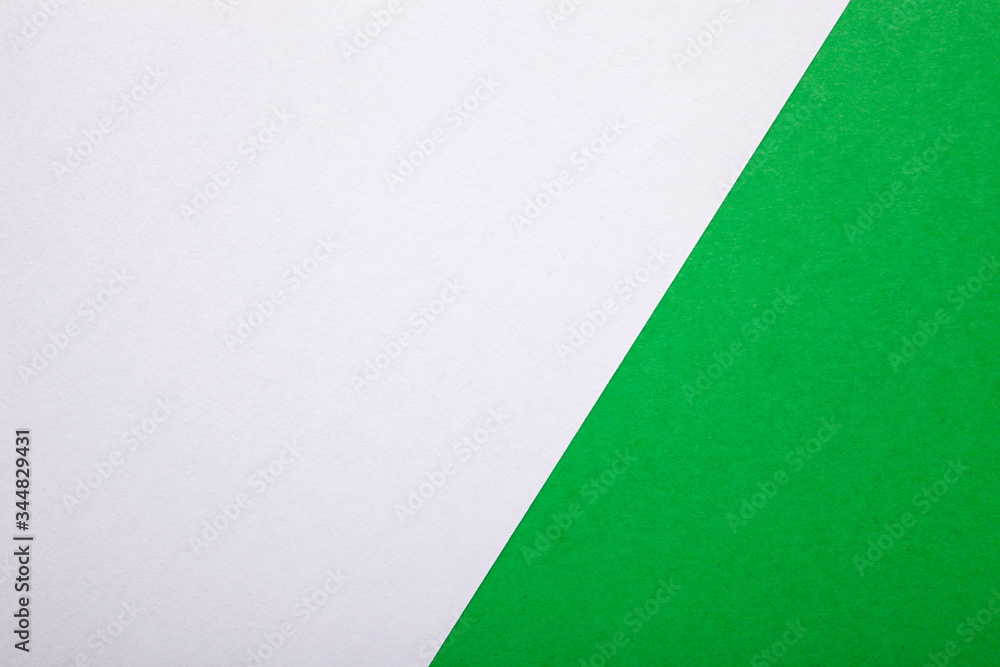 Green and white paper as background. Two colored bright paper texture, top view with place for text Green and white paper as background. Two colored bright paper texture, top view with place for text