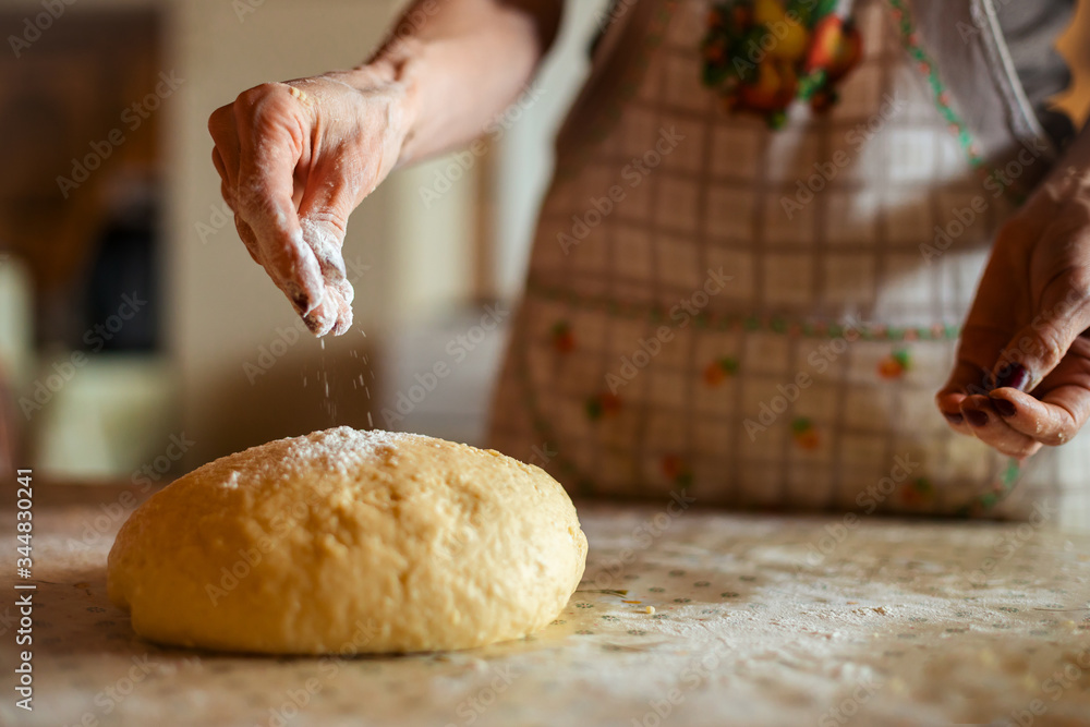 Mother preparing bread and pasta in traditional way. Mother's day concept