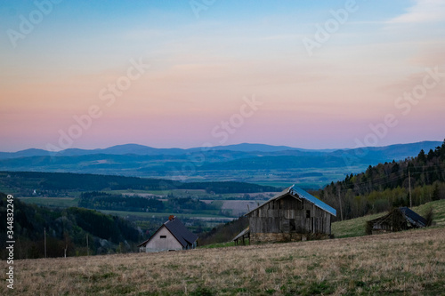 Mountain landscape with wooden hut during sunset time. Shot in Poland, Sudetes Mountains. 