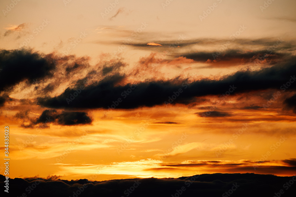 Beautiful landscape of nature and orange sunset in the sky with clouds and horizon in the evening. Colored background at the bottom