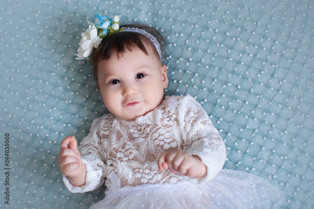 portrait of a baby girl on a blue background portrait of a baby girl on a blue background