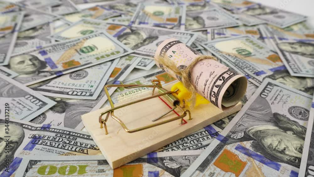 Dollar bill as a bait in a mousetrap. Money is like bait. Cheating, fraud and easy money concept. Free easy money in a mousetrap. Money background, blank mockup, place for text. Dollar bill as a bait in a mousetrap. Money is like bait. Cheating, fraud and easy money concept. Free easy money in a mousetrap. Money background, blank mockup, place for text.