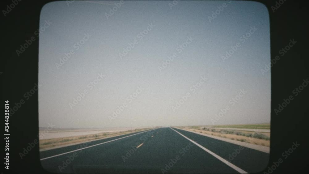 POV Driving along wide empty meadow on a sunny day. Point of view driving, first person. VINTAGE FILM. 