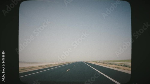 POV Driving along wide empty meadow on a sunny day. Point of view driving, first person. VINTAGE FILM. 