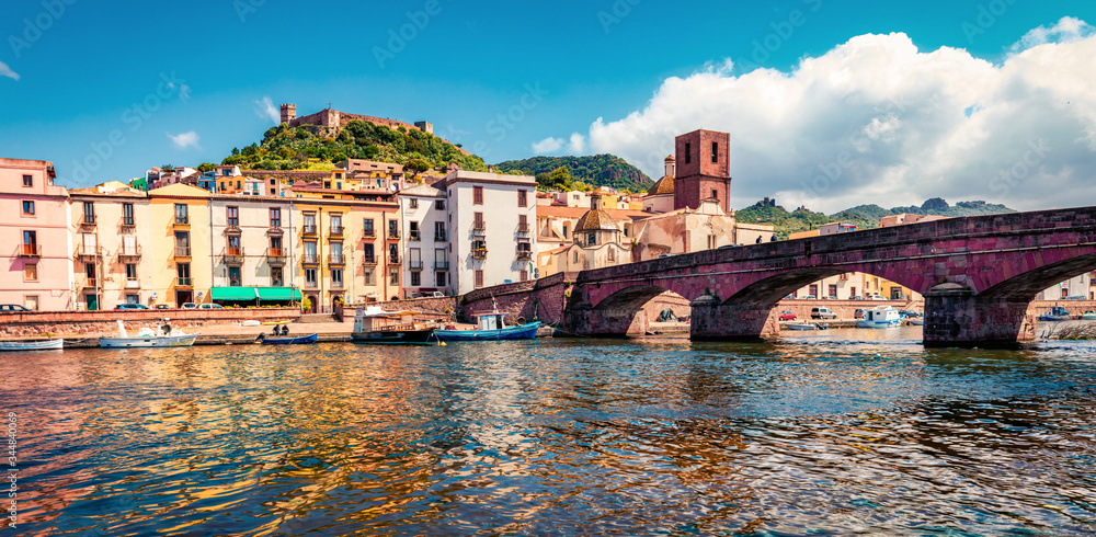 Panoramic summer cityscape of Bosa town with Ponte Vecchio bridge across the Temo river. Colorful morning view of Sardinia island, Italy, Europe. Traveling concept background.