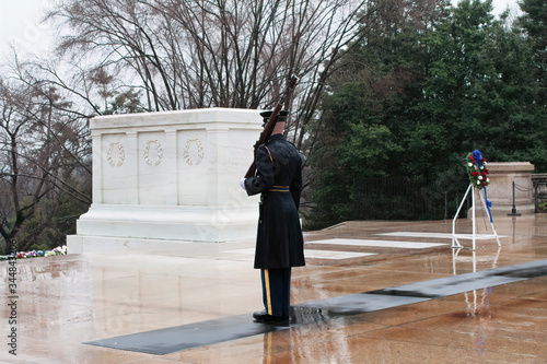 a soldier stands his post at the tomb of the unknown soldier.