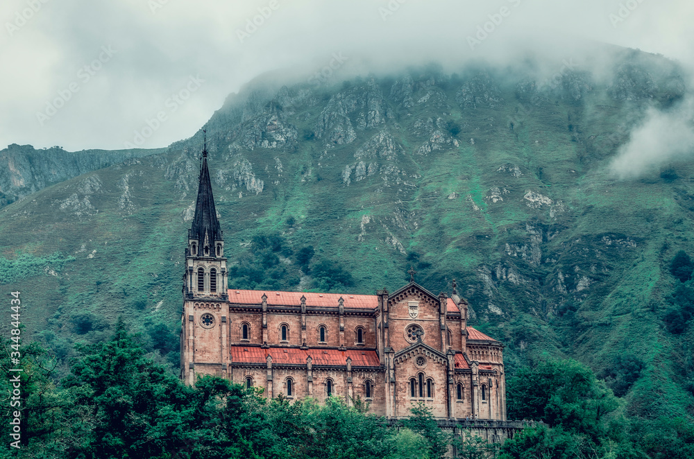View of the Basilica of Our Lady of Battles on a foggy day, Covadonga, Asturias, Spain 