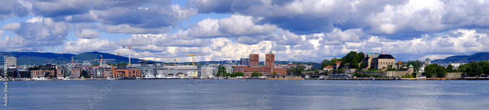 Obraz premium Oslo, Norway - Panoramic view of Oslo waterfront with Akershus Fortress, City Hall and Aker Brygge borough at Pipervika harbor