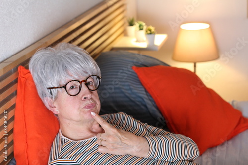 Senior woman thinking in bed 