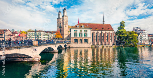 Bright sunny panorama of Zurich city, Switzerland, Europe. Picturesque afternoon view of Grossmunste - Protestant church reflected in Limmat River. Traveling concept background.