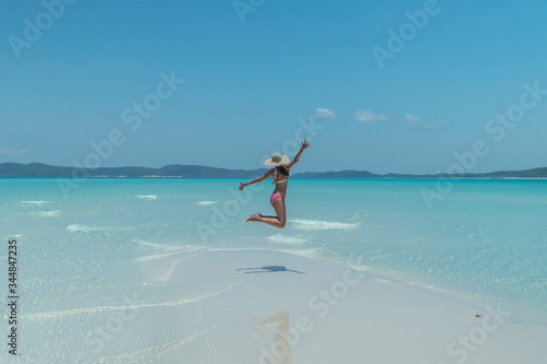 Fotografie, Obraz Woman jumping on blue beach