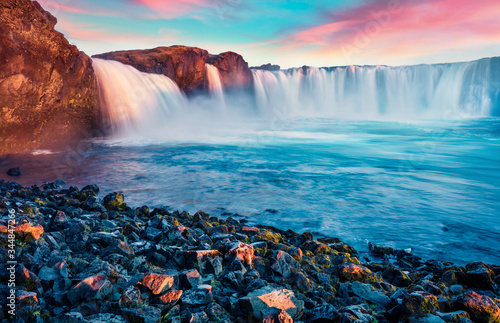 Stunning morning view of Skjalfandafljot river  Iceland  Europe. Picturesque summer scene of Godafoss  waterfall plunging over a curved  12m-high precipice  with paths to various viewpoints.