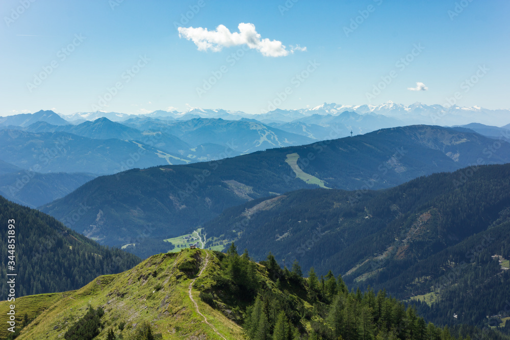 Beautiful Austrian alpine landscape scenery during summer with several mountain ranges in the distance