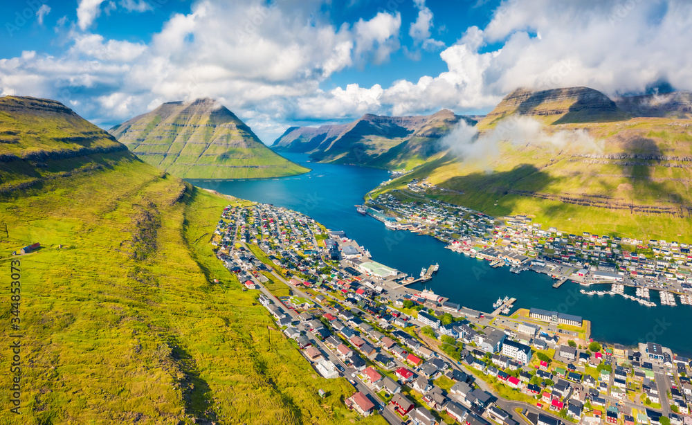 View from flying drone. Captivating summer cityscape of Klaksvik town. Aerial morning scene of Bordoy island, Faroe, Denmark, Europe. Traveling concept background.