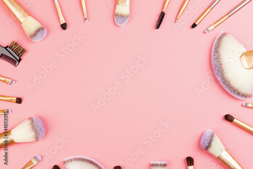 Cosmetic Makeup brushes on pink background. Flat lay, top view, copy space. Makeup accessories, mockup, template
