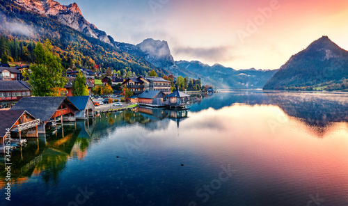 View from flying drone. Awesome sunrise on Grundlsee lake. Breathtaking morning view of Eastern Alps, Liezen District of Styria, Austria, Europe. Aerial cityscape of Grundlsee village.