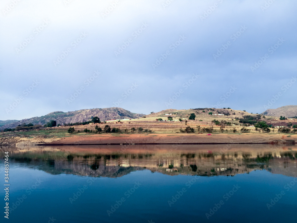 Reflection of land in clean still lake