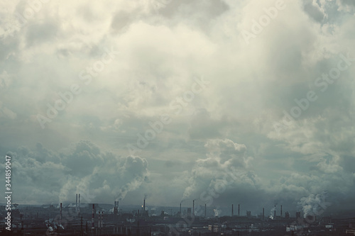 The effect of the old film. A metallurgical production complex with chimneys against a dark smoky sky. Environmental problems, environmental pollution, ecology