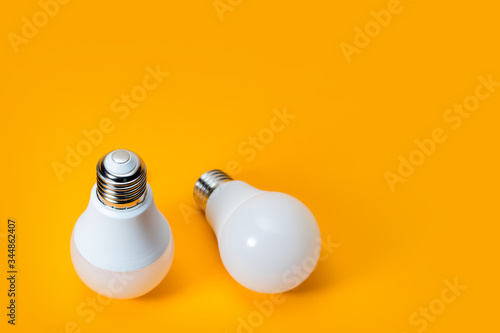 LED, New technology light bulb on yellow background, Energy super saving electric lamp is good for environment photo