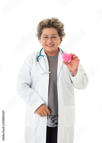 A asian senior female doctor wears glasses hold a heart shape model with smile and happy face isolated on white background