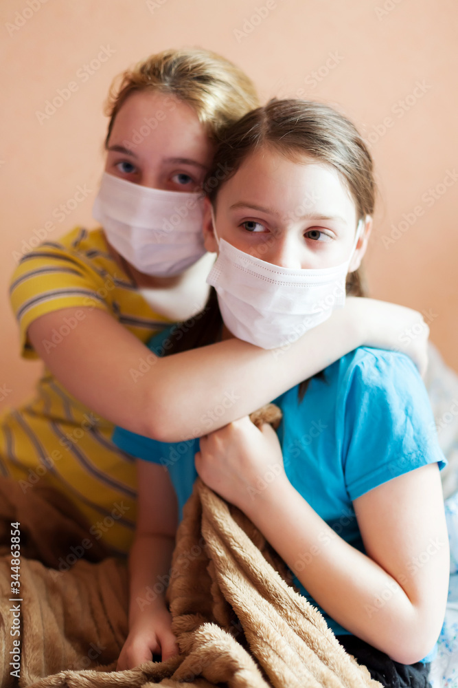   sick girls in   masks   at home.
