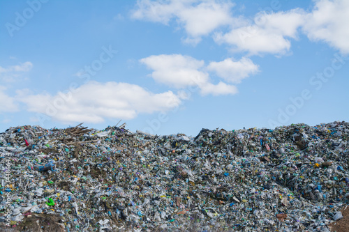 The mountain of plastic waste from urban communities and industrial districts and the blue sky