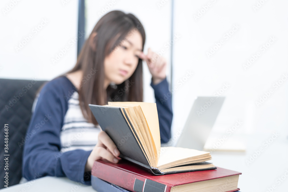 Young female sitting in living room and learning online Young female sitting in living room and learning online