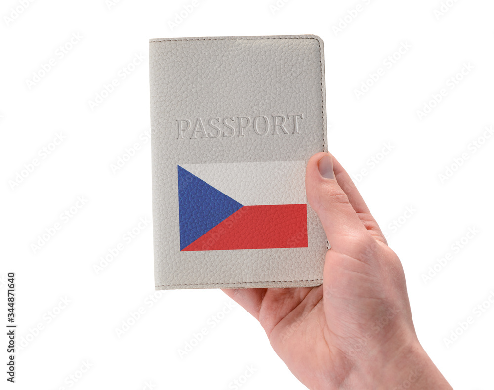 Czech passport in a man's hand on white background Czech passport in a man's hand on white background