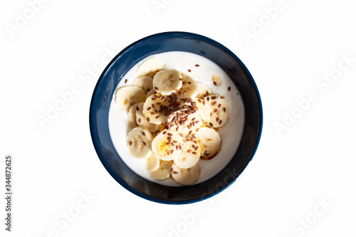 Yogurt with bananas, flax seeds and honey isolated on white background