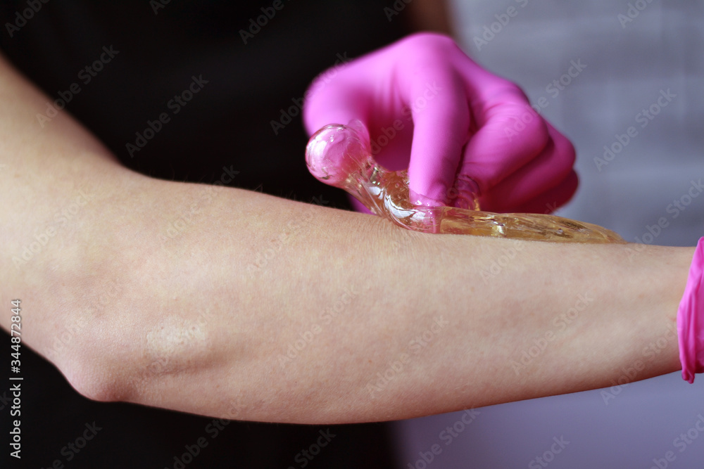 Fototapeta premium procedure shugaring girl does hair removal