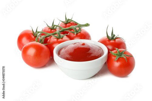 Branch of tomatoes and bowl with sauce isolated on white background