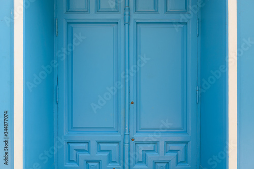 Blue painted door with white details on side © Ranta Images