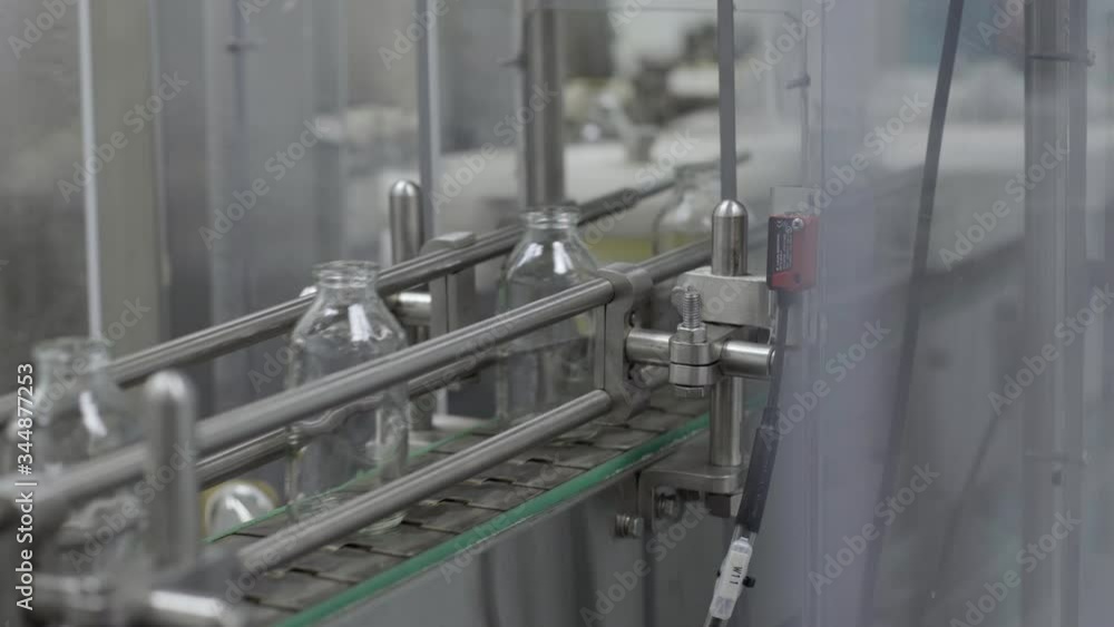 glass bottles on medical solution conveyor line close up medical industry glass bottles on medical solution conveyor line close up medical industry
