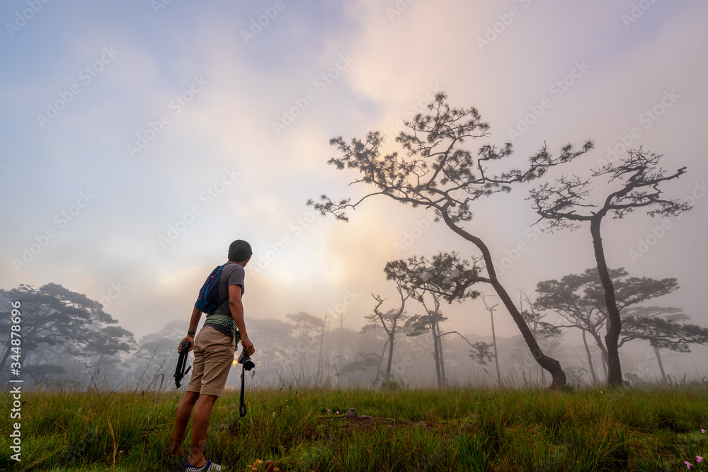 Silhouette of tourist young man  at sun rise time