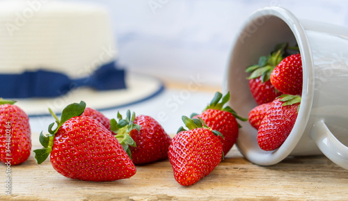 Strawberries in an iron mask. Fresh strawberries on a wooden table. Strawberry juice. strawberries on a natural background.