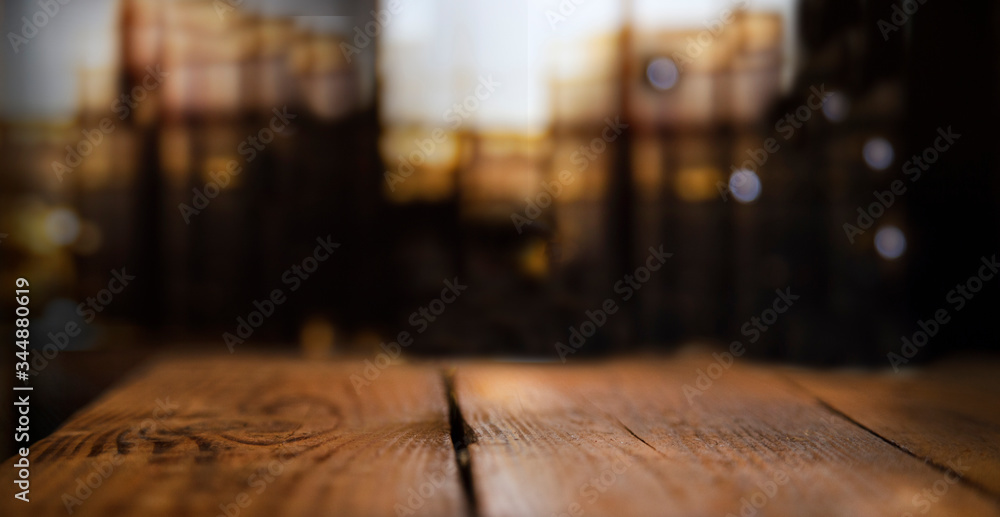 Empty wooden table top on blur light golden bokeh of cafe restaurant, bar in a dark background. Empty wooden table top on blur light golden bokeh of cafe restaurant, bar in a dark background.