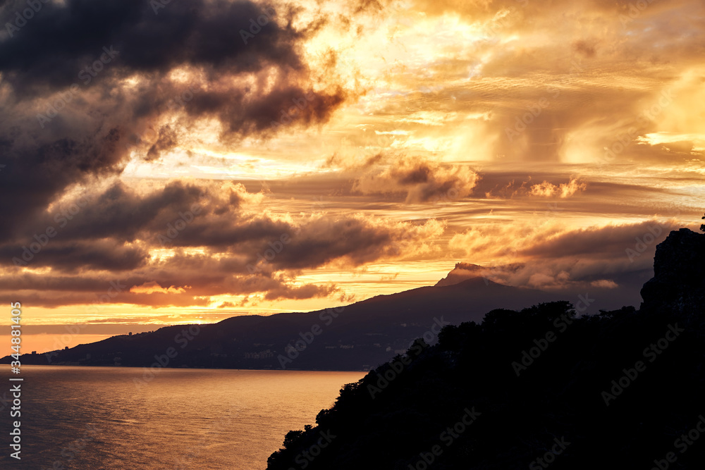 
sunset over the sea. clouds, mountains mountains 