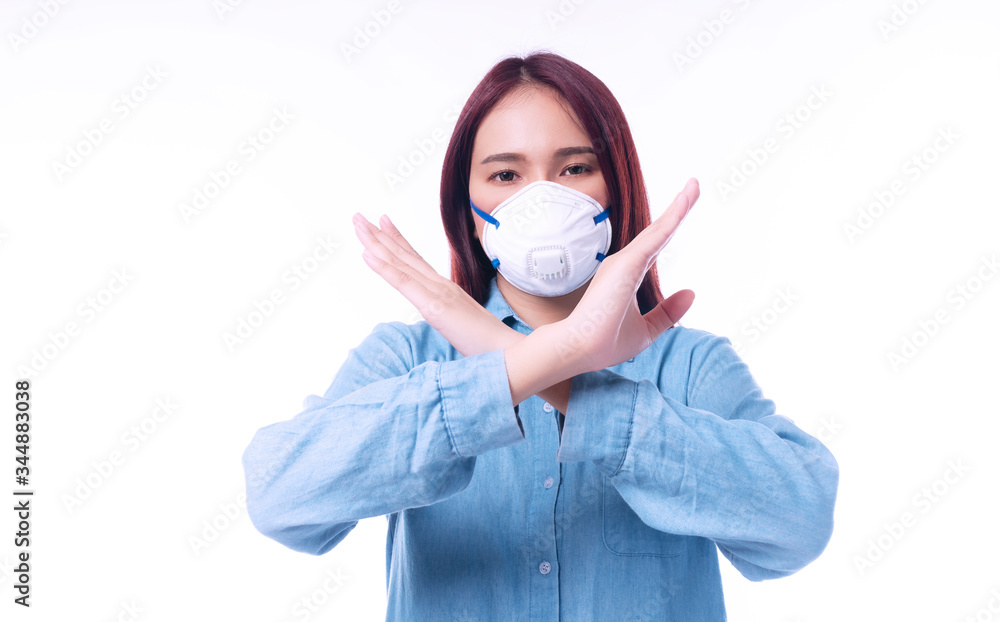 Unhappy young woman wearing protection face mask with filter pm2.5 anti pollution, viruses while making cross hands stop gesture on isolated on white background. Air pollution, environmental concept Unhappy young woman wearing protection face mask with filter pm2.5 anti pollution, viruses while making cross hands stop gesture on isolated on white background. Air pollution, environmental concept