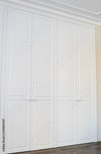 White cabinet doors with brown floor handles