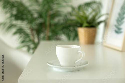 Wallpaper Mural Cup of coffee on the white table near the flowers. White cup of tea for coffee brake Torontodigital.ca