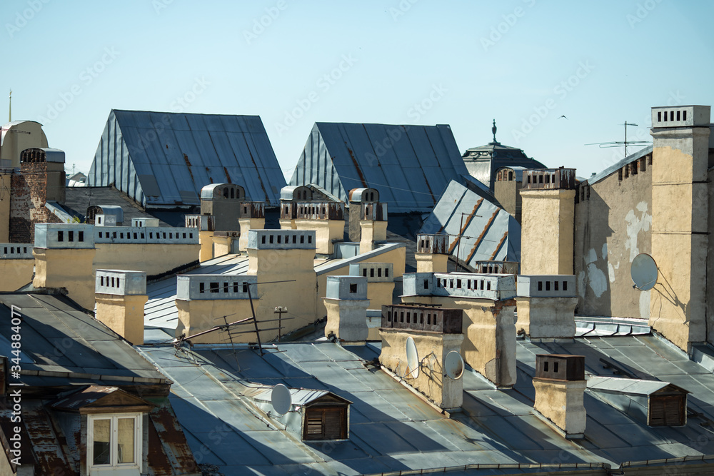 View at the top of the roofs. Blue sky and old roof of ancient city