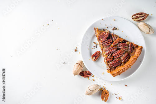 фотографія Homemade autumn pecan pie on white background, Traditional fall and winter, than