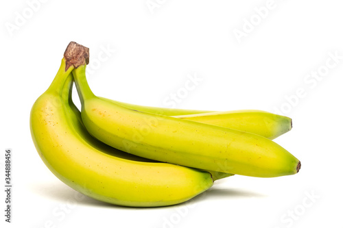 A bunch of partially ripe bananas on a white background.